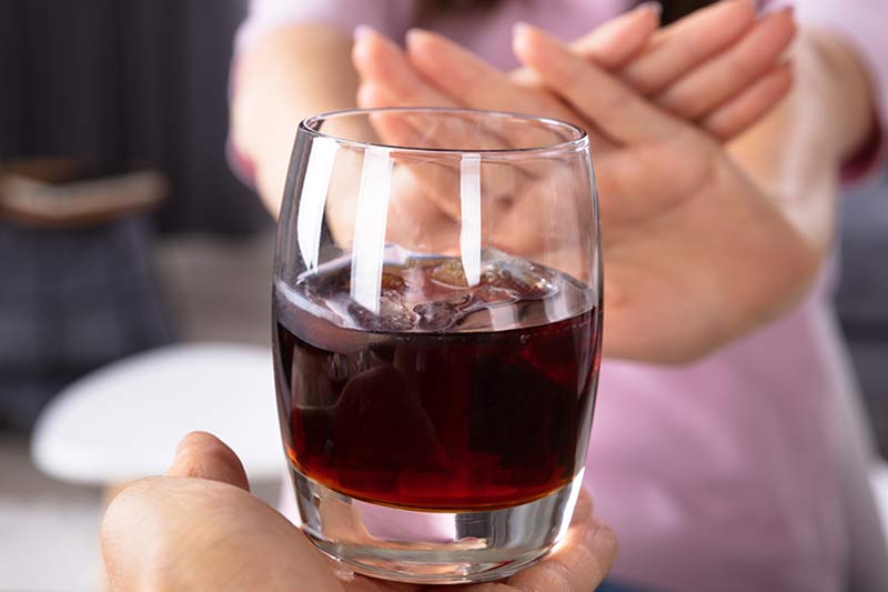 Avoiding alcohol and nicotine as part of the Kybella aftercare process.